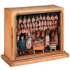 a wooden box with figurines in it