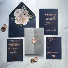 the wedding stationery is laid out on top of each other, with coins scattered around it