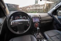 the interior of a car with black leather seats and dash lights, steering wheel controls and dashboard gauges