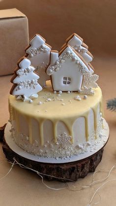 a decorated cake sitting on top of a table next to a christmas tree and presents