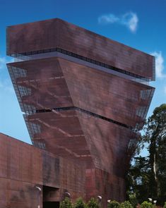 an unusual building that looks like it is made out of red bricks