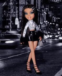 a black and white photo of a doll on the street at night with city lights in the background