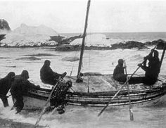 an old black and white photo of people in a boat