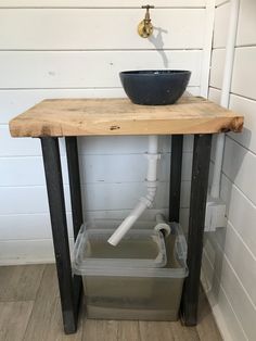 a sink and faucet in a room with wood flooring on the walls