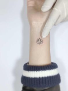 a person with a small tattoo on their wrist