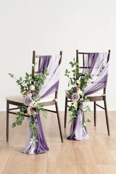 two chairs with purple sashes and flowers on them, sitting side by side next to each other