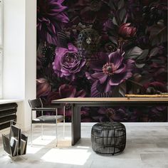 a dining room table with purple flowers painted on the wall and chairs in front of it