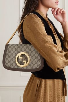 Gucci revived its iconic 'Blondie' bag, and this latest version is as equally chic and timeless as its predecessors. Made from monogrammed coated-canvas and textured-leather in a simple, clean-lined silhouette, it's detailed with the house's interlocking 'GG' motif at the front and sized to fit just the essentials. Detach the logo-detailed chain to carry it as a clutch. Gucci Bags Handbags, Ysl Purse, Celebrity Bags, Gucci Clutch, Gucci Tote Bag, Handbag Heaven, Print Coat, Designer Crossbody Bags, Handbag Shoes