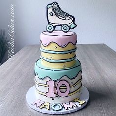 a three tiered cake decorated with roller skates and the number 10 on top