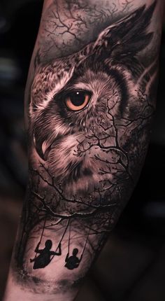 an owl with two people on a swing in front of it's eyes and tree branches