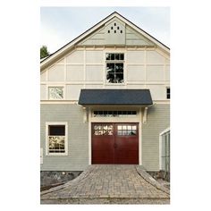 a house with a red door and brick walkway