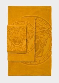 two yellow towels with an image of a tiger on them