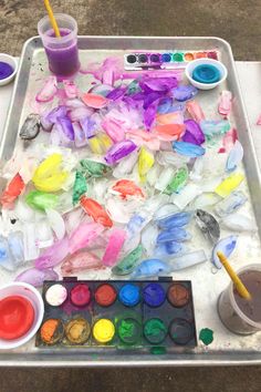 an artist's palette with paint and watercolors in it on a tray