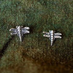 These Dragonfly Stud Earrings are the perfect everyday accessory. Crafted from sterling silver, dragonflies symbolize strength and change. Elevate any outfit with these delicate yet impactful studs. DRAGONFLY STUD EARRING DETAILS: Sterling silver (.925). Dragonflies measure approx. 8 mm. Stud earrings with a post and ear nut closure. Bee Studs, Busy Bees, Jewelry Card, Everyday Accessories, Dragonflies, Stud Earring, Bumble Bee, Ring Necklace, Nature Inspired