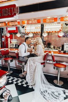 a man and woman sitting at a diner