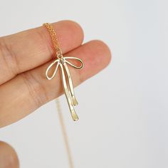 "Beautiful and lovely small gold bow charm necklace. Made of gold-filled long tail gold bow charm with skinny gold plated brass chain. Soft and warm. Great for gift, everyday or special occasion.  Your item will ship in a gift box. Please feel free to contact me if you have any questions. ♥ Chain Length 14\"-20\" ♥ Bow Charm  3/4\"x1 1/4\"  ♥ Gold plated brass chain / Gold filled bow charm  ♥  See more Rudiana Accessories  Rudiana.etsy.com" Gold Necklace With Bow As Gift, Necklace Tie, Birthday Gift Best Friend, Bow Choker, Bow Charm, Bow Necklace, Gift Best Friend, Bow Knot, Tie The Knot