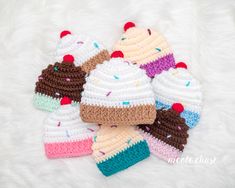 crocheted ice cream hats and mittens are on a white furnishing