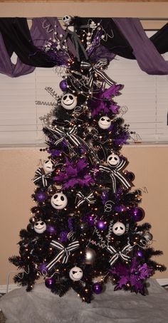 a decorated christmas tree with black and purple decorations