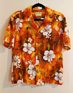 Vintage   UI MAIKAI Orange White Brown  Floral Hawaiian Shirt  Made in Hawaii  Excellent Conditions for this 1960 Hawaiian ALOHA Shirt with No stain or Holes, Short Sleeve, Front Pocket and Original Gold Buttons  The Floral Orange White Brown Pattern Color Still Bold and Bright 100% COTTON SIZE SMALL SHOULDER TO SHOULDER......18" ARMPIT TO ARMPIT.................22.4" LEIGHT.........................................27" Please feel free to contact us with any condition queries you may have prefera Retro Fitted Printed Hawaiian Shirt, Retro Collared Hawaiian Shirt, Spring Vintage Hawaiian Shirt With Retro Print, Fitted Vintage Collared Hawaiian Shirt, Vintage Fitted Collared Hawaiian Shirt, Vintage Hawaiian Shirt With Floral Print, Retro Printed Hawaiian Shirt, Vintage White Hawaiian Shirt With Camp Collar, Vintage White Collared Hawaiian Shirt