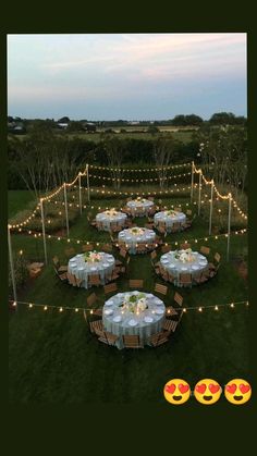 an aerial view of a table set up for a formal dinner in the middle of a field