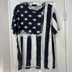 an american flag t - shirt hanging on a door