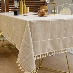 a white table cloth with tassels on it