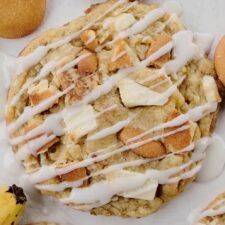 a cookie covered in icing next to some cookies