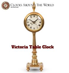 a gold clock with roman numerals on it and the words victoria table clock