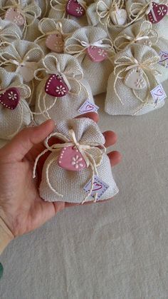 someone is holding small bags with hearts on them