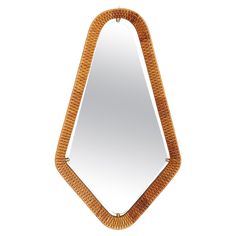 a mirror that is made out of wood and has an unusual design on the front