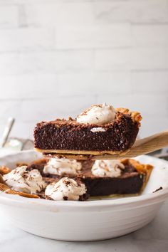 two pieces of chocolate cake on top of each other with whipped cream in the middle