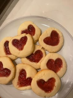 heart shaped cookies on a plate with jam in the shape of a heart are ready to be eaten