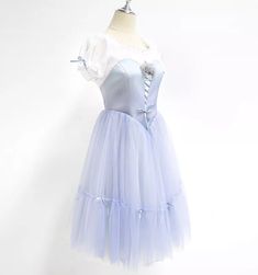 Extremely Romantic and feminine tutu for the role of Giselle in Act 1. This professional, Romantic tutu features an enchanting shade of very pale corn blue. The V-shaped bodice is made with high quality satin, and features a white draped undershirt with round neck, short sleeves and the typical laced pattern, decorated by a silk pale blue rose. The Romantic tutu skirt is made with the softest tulle, in order to flow with the dancer's movements. The skirt is decorated with silk pale blue ribbons. Balletcore Tulle Petticoat, Fitted Tulle Tutu Dress In Fairytale Style, Light Blue Fitted Tutu Dress For Wedding, Fitted Light Blue Tutu Dress For Wedding, Elegant Light Blue Tulle Tutu Dress, Balletcore Tulle Dress For Dance, Romantic Tutu, White Drapes, Ballet Costumes