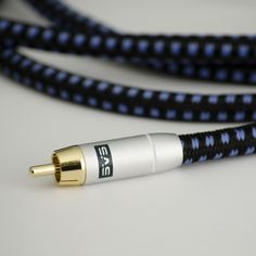 a black and white cable with gold ends