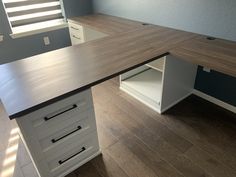 an office desk with two drawers on the bottom and one drawer in the middle that is open