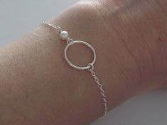 Eternity Circle, Karma Circle & Pearl Bracelet ALL PARTS ARE SOLID STERLING SILVER *White swarovski pearl is 4mm *circle charm measures 15mm *Sturdy chain clasps closed with a larger and thicker spring style clasp *Boxed individually & ready to give Notes: Great quality bracelet. Delicate look but made with high quality materials that really hold up! All done in solid sterling silver. Minimalist Sterling Silver Pearl Bracelet For Wedding, Minimalist Sterling Silver Bracelet For Wedding, Wedding Sterling Silver Round Pearl Bracelet, Delicate Sterling Silver Bracelet For Wedding, Dainty Sterling Silver Bracelet For Wedding, Wedding Sterling Silver Pearl Bracelet, Round Sterling Silver Wedding Bracelet, Karma Bracelet, Silver Bridesmaid