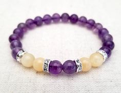 Feel fancy with this stunning 8mm bright purple Amethyst and Pale Yellow Honey Calcite Beaded Stretch Bracelet. Enjoy peace and calm with the highly spiritual Amethyst crystal while the Honey Calcite further amplifies the energy of the purple stone!  ♦︎ 8mm genuine Amethyst and Honey Calcite gemstone beads ♦︎ Sterling Silver Plated Brass with Austrian Crystal Rhinestone Accent Beads  ♦︎ Double strung on durable stretch cord ♦︎ Stone color and clarity may vary ♦︎ Comes with a description card ♦︎P Beaded Bracelet Diy, Stretchy Beaded Bracelet, Stone Accessories, Honey Calcite, Diy Jewelry Unique, Nails Desing, Gemstone Beaded Bracelets, Pretty Bracelets, Stretchy Bracelets