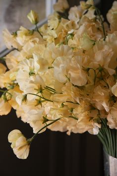 a vase filled with yellow flowers on top of a table