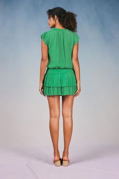 Done in a verdant shade, this short-sleeve mini dress ties up at the neckline and cinches in at the waist before falling to a thigh-skimming tiered hem with crisp, raw edges. The perfect one-and-done number for date night - not to mention one of Current Air's most popular dress. •V-neckline with tie •Relaxed fit •Ruffle trim •Pleated cap sleeves •Elasticized waist •Tiered pleated skirt •Raw edges Item number 1990061-1100% Polyester Dry clean Imported Green Mini Dress With Ruffle Hem, Green Ruffled Mini Dress, Green Knee-length Mini Dress With Ruffle Hem, Green V-neck Short Sleeve Dress For Spring, Green V-neck Short Sleeve Spring Dress, Chic Green Mini Dress With Ruffle Hem, Green V-neck Dress With Pleated Waist, Fitted Green Short Sleeve Dress For Spring, Chic Green Tiered Dress