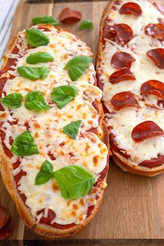 two slices of pizza with basil and pepperoni