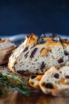 bread with raisins and herbs on a cutting board