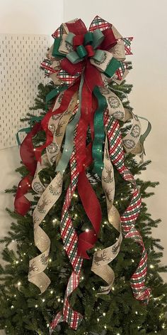 a christmas tree decorated with ribbons and bows