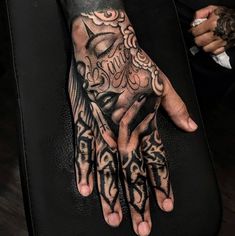 a person with tattoos on their hands and hand