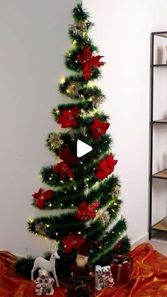 a small christmas tree with red and gold decorations