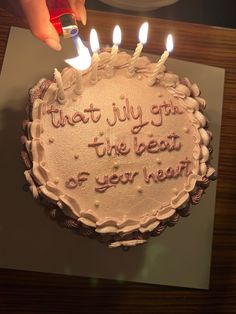 a birthday cake with lit candles on it that says, that july get the best of your next