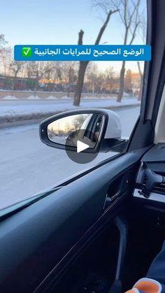 a man driving a car in front of a rear view mirror