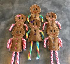 four gingerbread man made out of candy canes