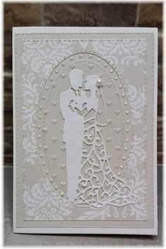 a wedding card with the silhouette of a bride and groom