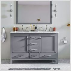 a bathroom vanity with two sinks and a large mirror over the top that hangs above it