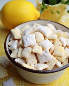 a bowl filled with marshmallows next to a lemon